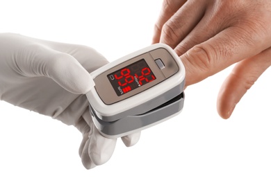 Photo of Doctor checking patient's oxygen level with pulse oximeter on white background, closeup