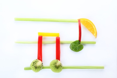 Photo of Musical notes made of fruits and vegetables on white background, top view