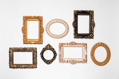 Photo of Empty vintage frames hanging on white wall