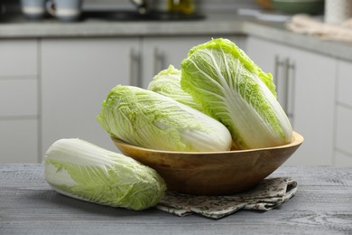 Photo of Fresh Chinese cabbages on grey wooden table