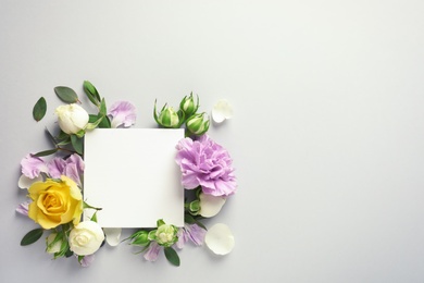 Flat lay composition with beautiful blooming flowers on grey background