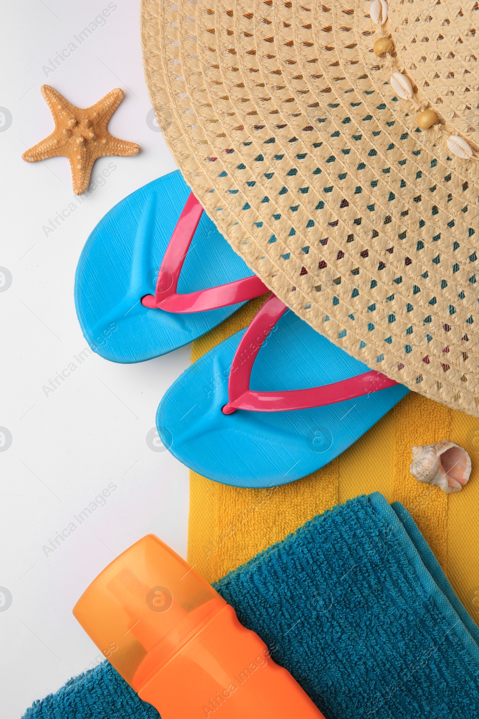 Photo of Flat lay composition with beach accessories on white background