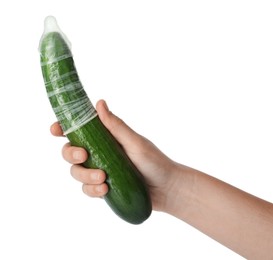 Photo of Woman holding cucumber in condom on white background, closeup. Safe sex concept