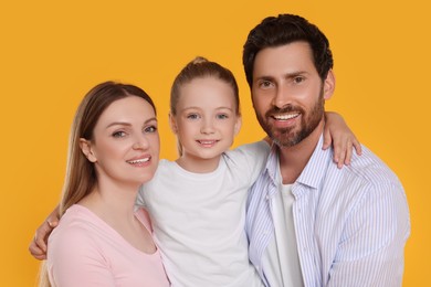 Photo of Portrait of happy family on orange background