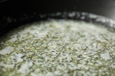 Photo of Melting butter in frying pan, closeup view