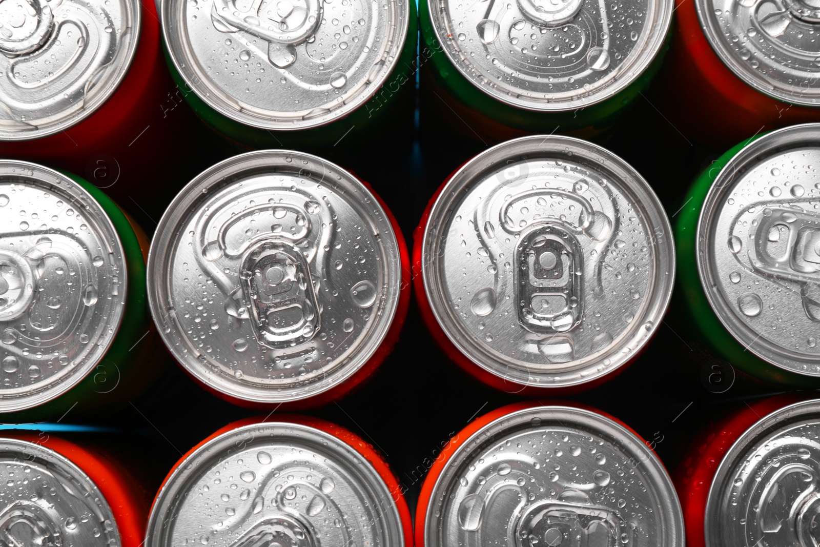 Photo of Energy drinks in wet cans, top view. Functional beverage