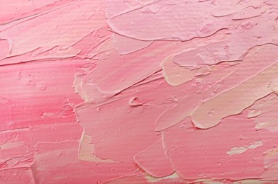 Photo of Beautiful strokes of pink and white oil paints as background, closeup