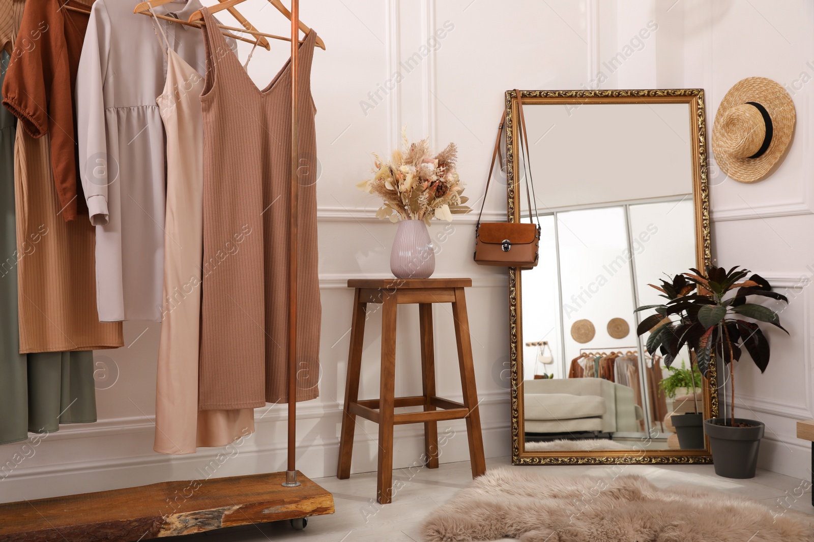 Photo of Dressing room interior with large mirror and stylish clothes