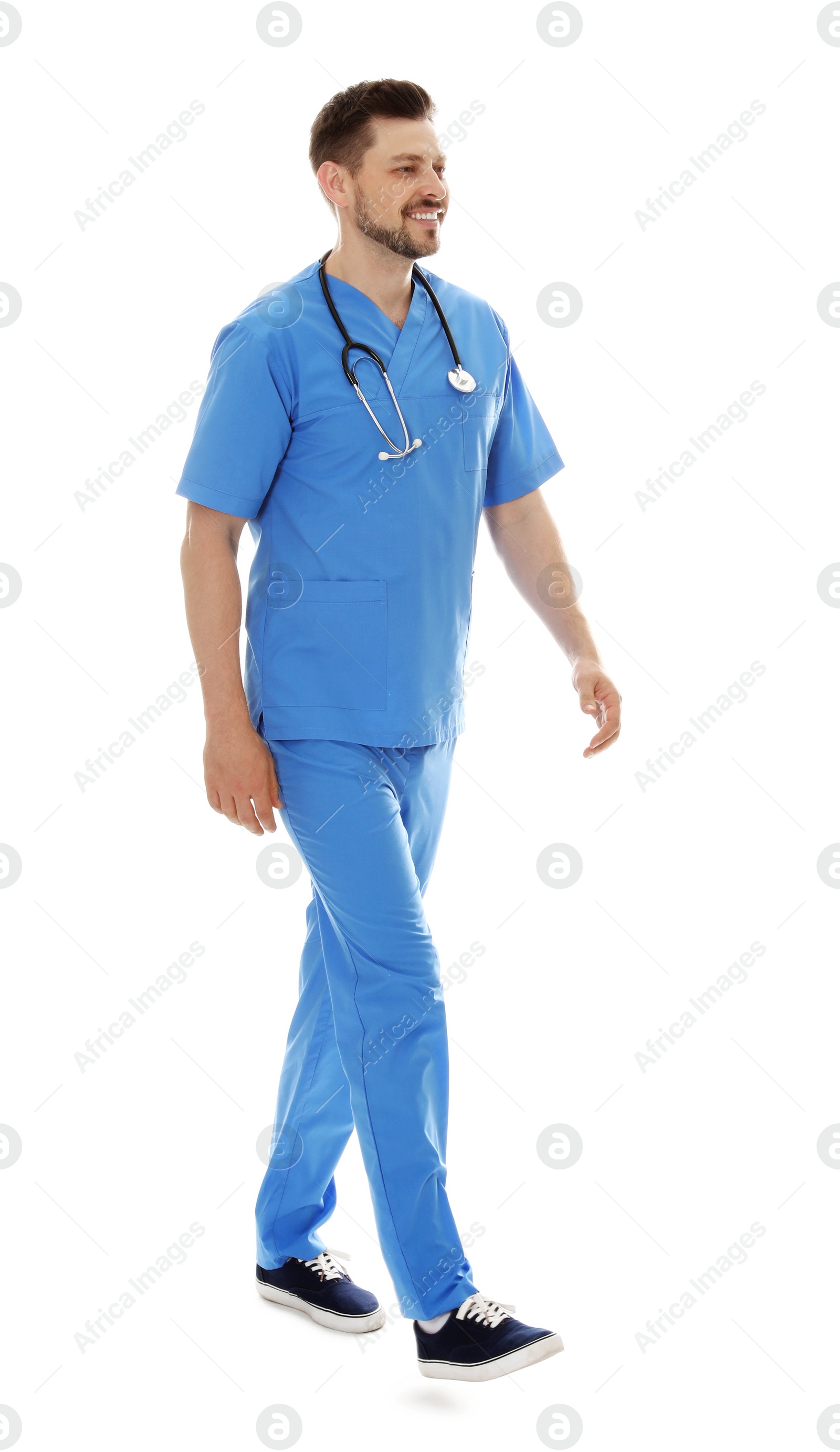 Photo of Full length portrait of smiling male doctor in scrubs isolated on white. Medical staff