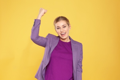 Photo of Happy young businesswoman celebrating victory on color background
