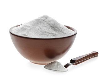 Photo of Bowl and spoon of baking soda isolated on white