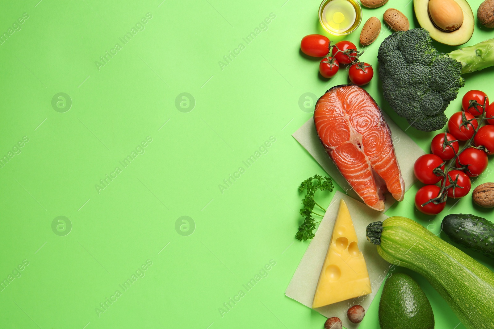 Photo of Different products on light green background, flat lay with space for text. Keto diet