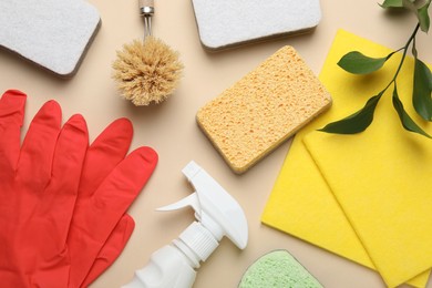 Photo of Flat lay composition with sponges and other cleaning supplies on beige background