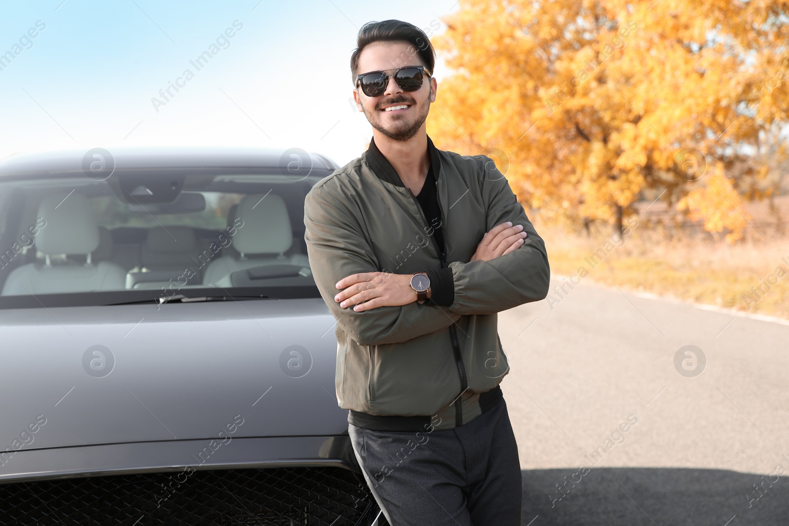 Photo of Young man near modern car on sunny day, outdoors