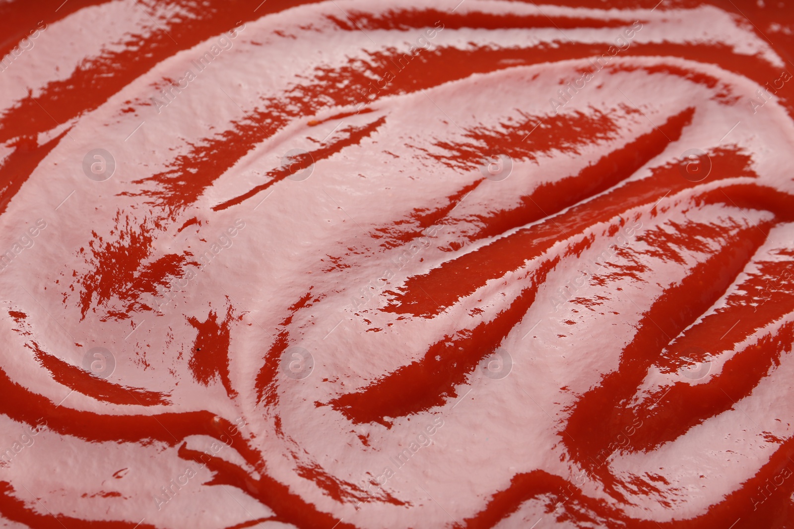 Photo of Tasty ketchup as background, closeup. Tomato sauce