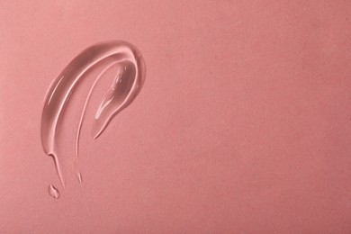 Photo of Sample of cosmetic gel on pink background, top view. Space for text