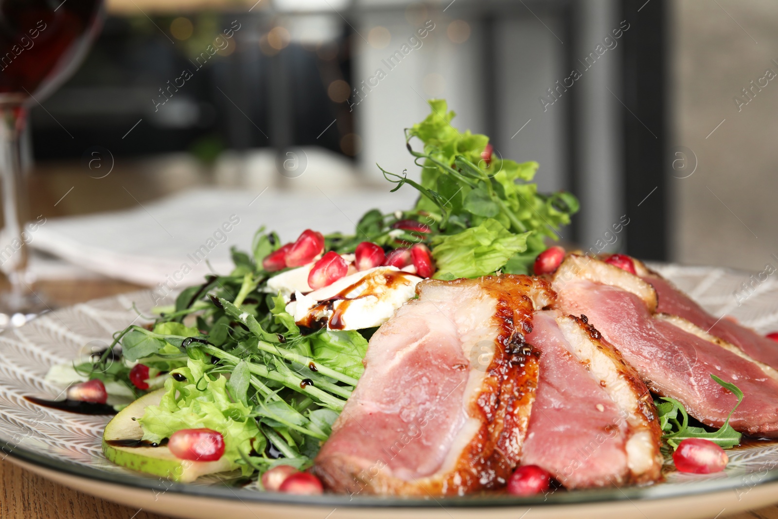 Photo of Delicious salad with roasted duck breast on plate, closeup