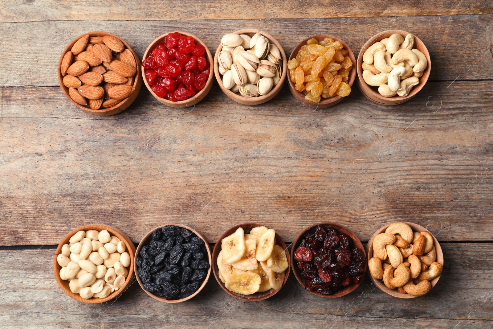 Photo of Composition of different dried fruits and nuts on wooden background, top view. Space for text