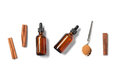 Photo of Flat lay composition with cinnamon essential oil on white background