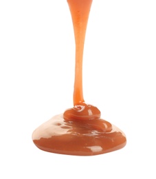 Pouring sweet caramel sauce on white background