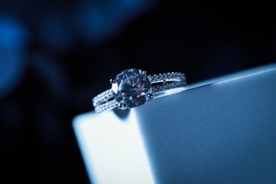 Photo of Elegant jewelry. Stylish presentation of luxury ring on podium, closeup