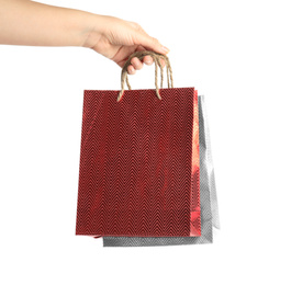 Photo of Woman holding paper shopping bags on white background, closeup. Space for design