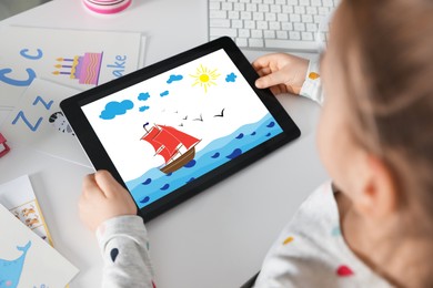 Little girl holding tablet with cute drawing at home. Child art