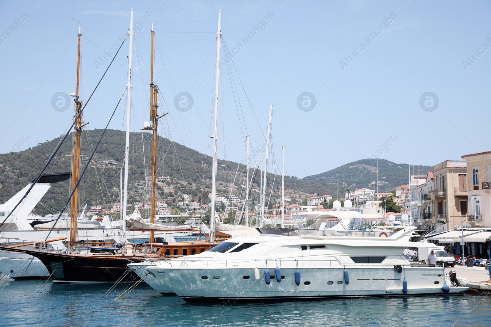 Photo of Beautiful view of different boats in sea near shore on sunny day