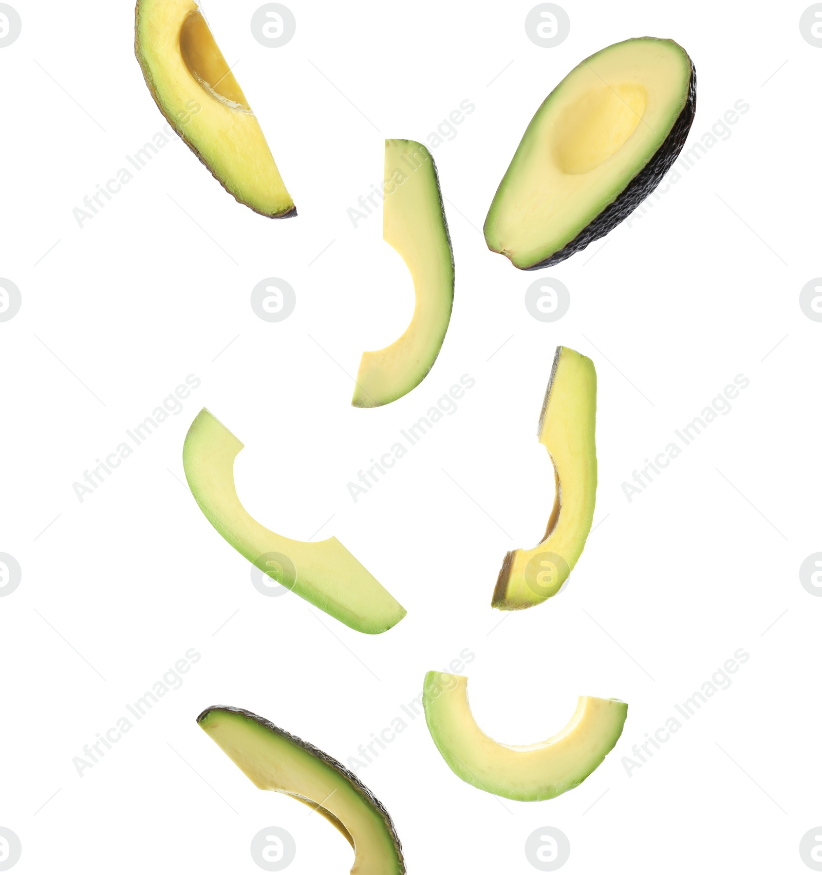 Image of Falling fresh ripe avocados on white background