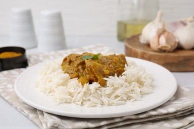 Photo of Delicious chicken curry with rice on table, closeup