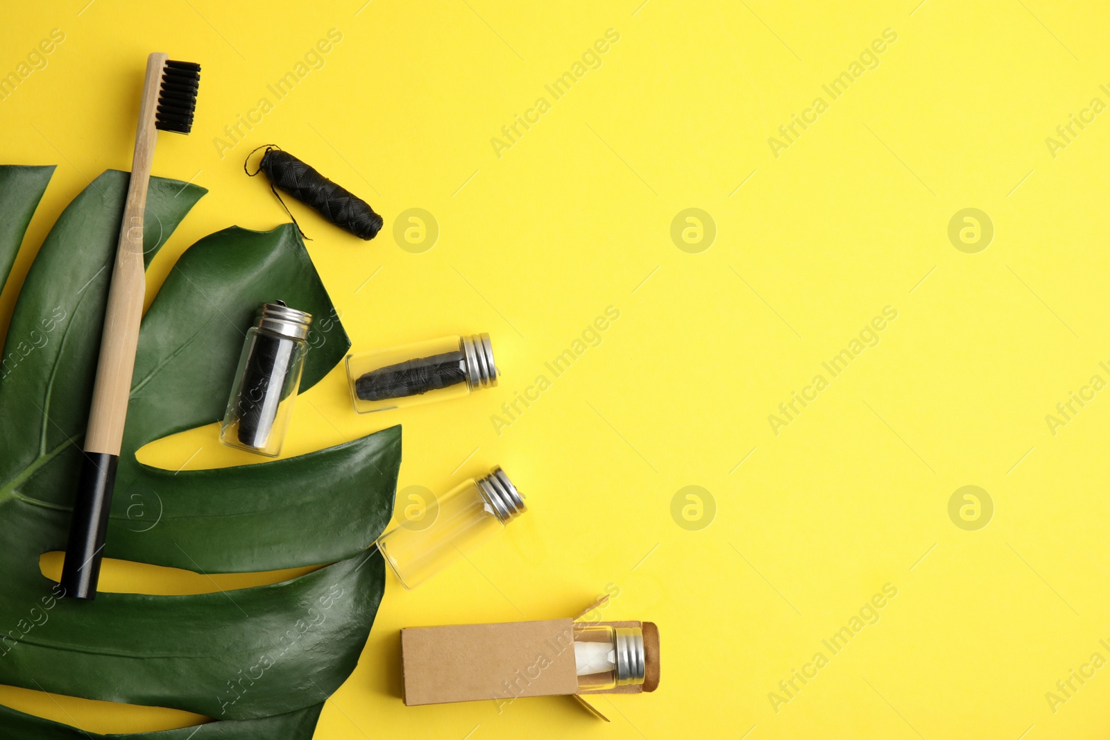 Photo of Flat lay composition with natural dental floss on yellow background. Space for text