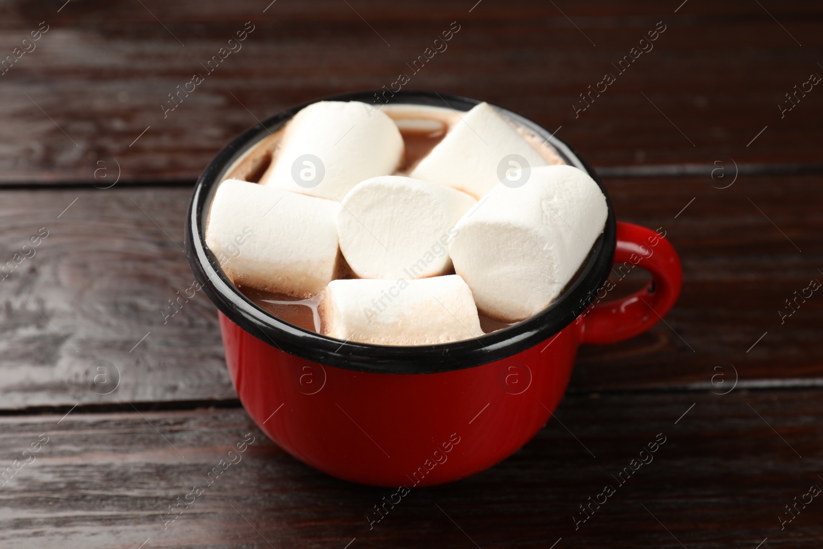 Photo of Tasty hot chocolate with marshmallows on wooden table, closeup