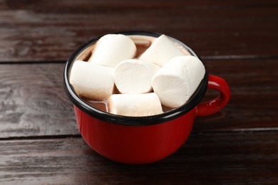 Photo of Tasty hot chocolate with marshmallows on wooden table, closeup