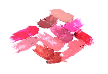 Photo of Smears of different bright lipsticks on white background