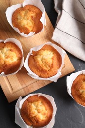 Photo of Tasty muffins on grey table, flat lay. Fresh pastry