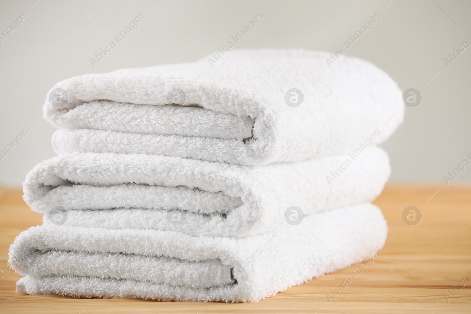 Photo of Stack of folded towels on wooden table