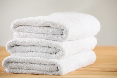 Stack of folded towels on wooden table