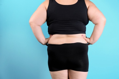 Overweight woman before weight loss on color background