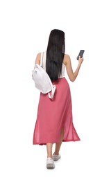 Photo of Young woman using smartphone while walking on white background, back view