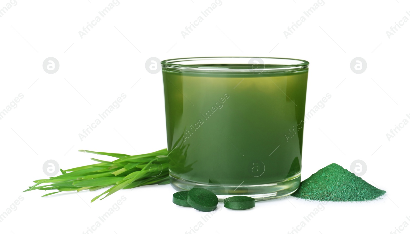 Photo of Glass of spirulina drink, powder, pills and wheat grass on white background