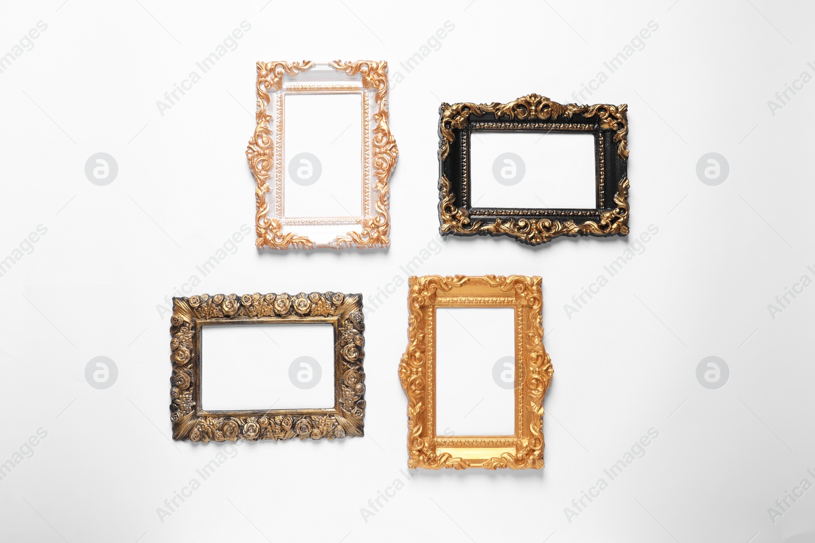 Photo of Blank vintage frames hanging on white wall
