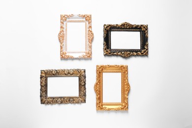 Photo of Blank vintage frames hanging on white wall