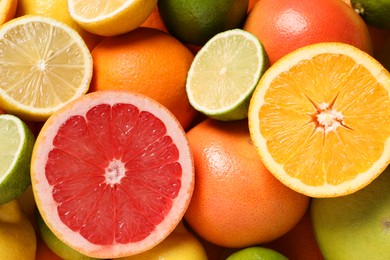 Photo of Different fresh citrus fruits as background, top view