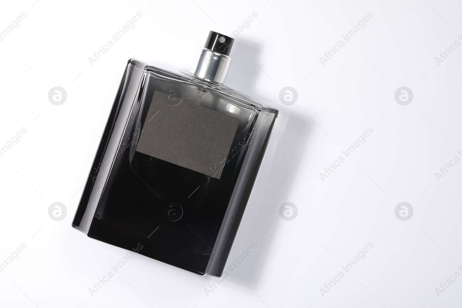 Photo of Luxury men`s perfume in bottle on white background, top view. Space for text