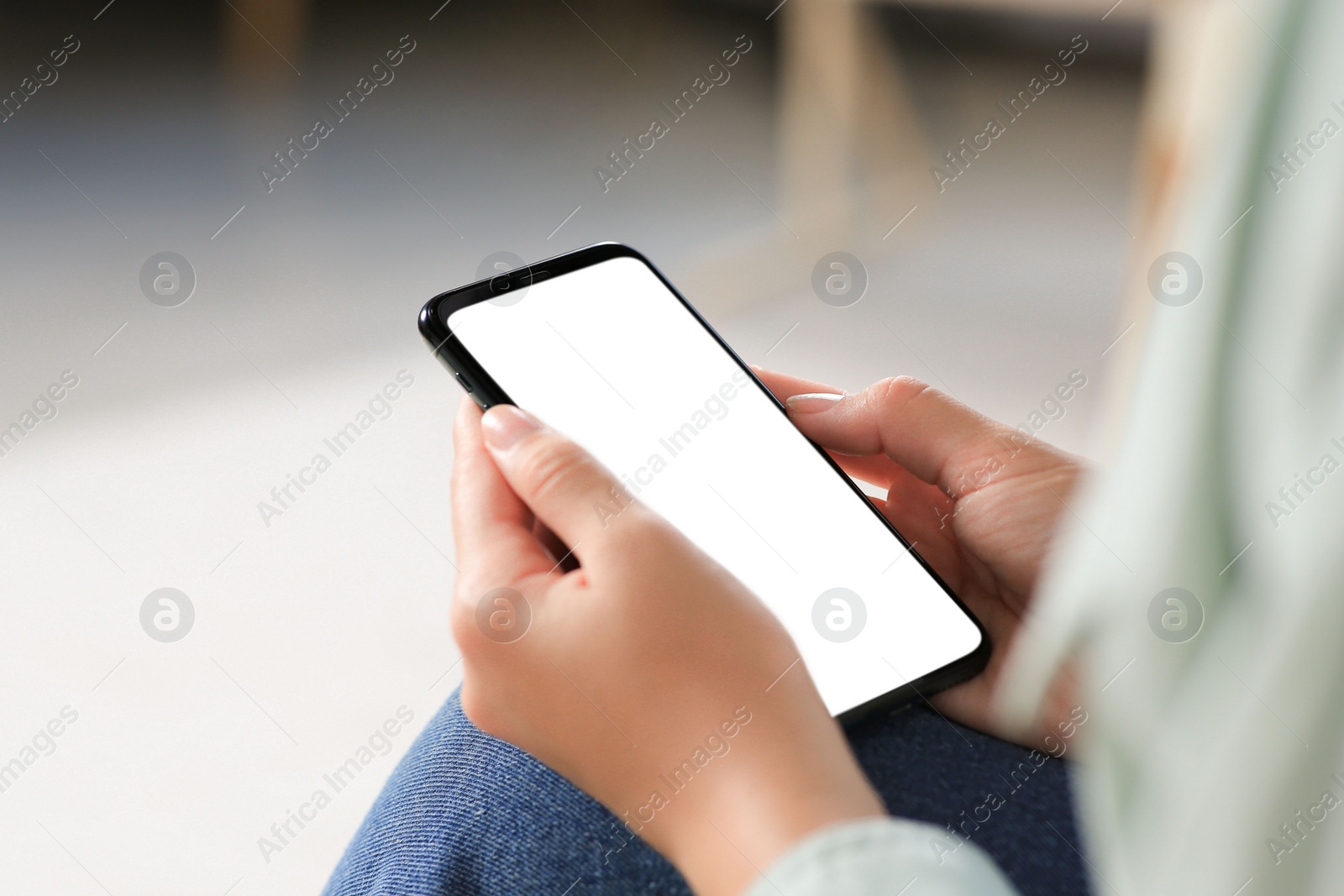 Photo of Closeup view of woman with smartphone indoors. Space for text