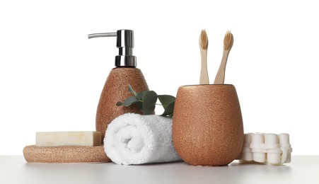 Photo of Bath accessories. Different personal care products and eucalyptus branch on table against white background