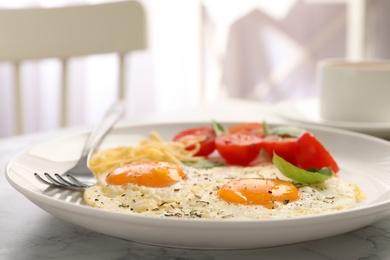 Tasty breakfast with fried eggs on table, closeup