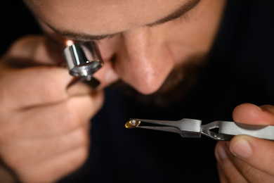 Photo of Professional jeweler working with gemstone, closeup view