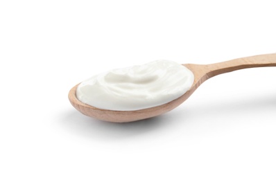 Photo of Wooden spoon with sour cream on white background