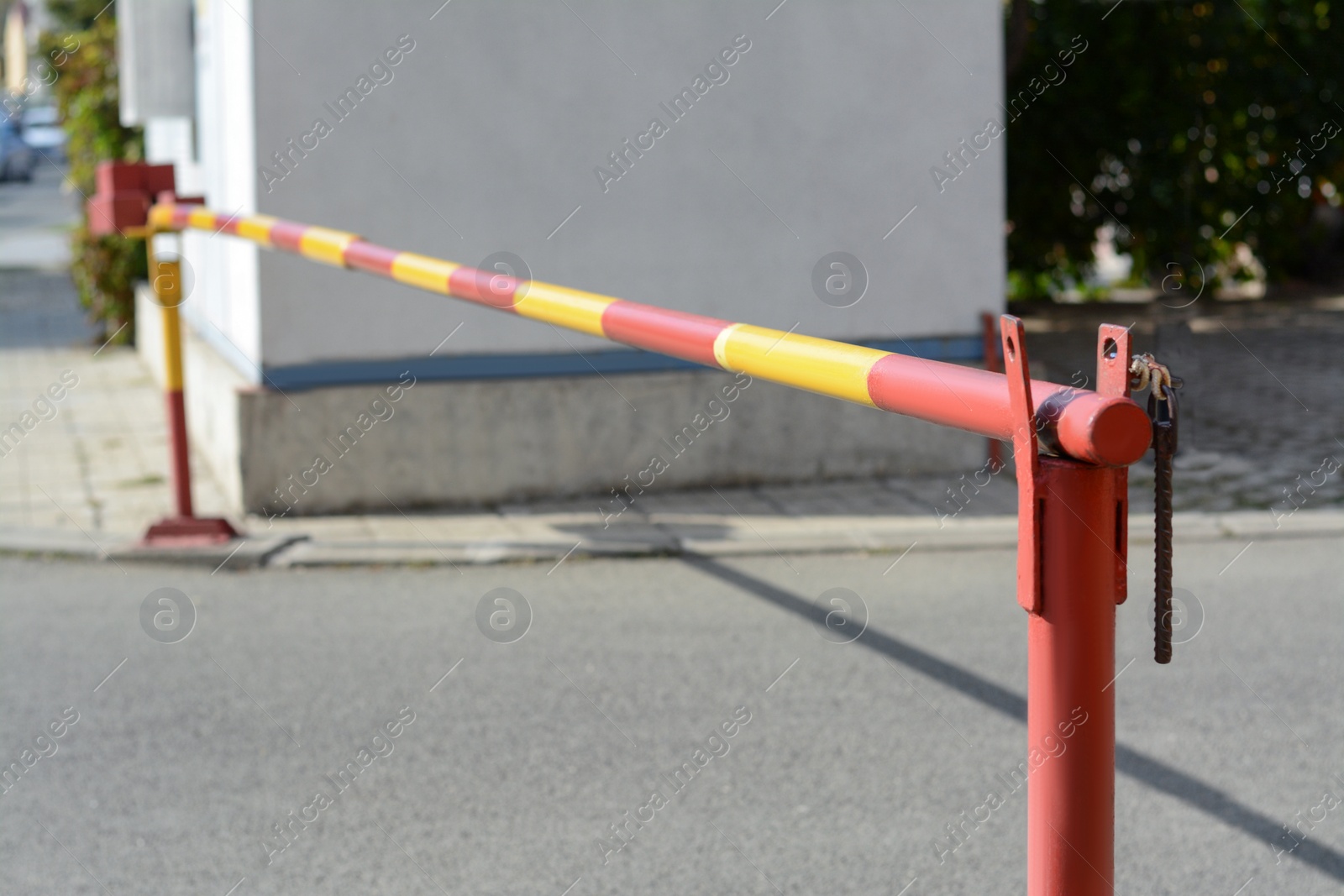 Photo of Closed boom barrier on sunny day outdoors